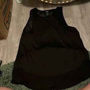 Black athletic tank top with mesh around the arms and at the bottom